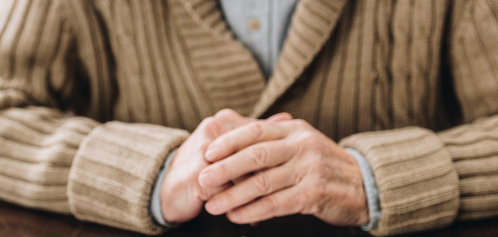 cropped view of senior man playing with puzzles on table