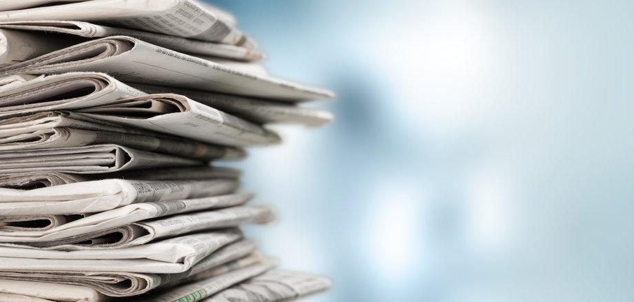 Pile of newspapers on white background