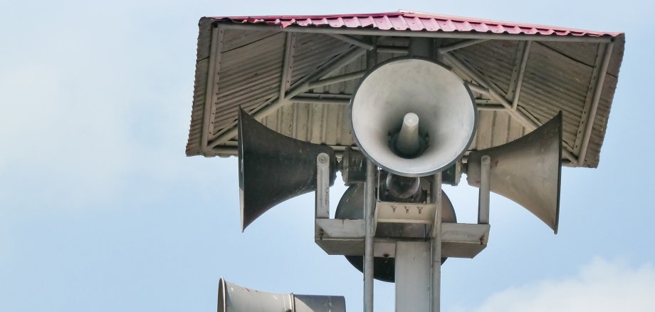 Vintage horn speaker tower with loudspeaker against the sky. Sys Vintage horn speaker tower with loudspeaker against the sky. Sys