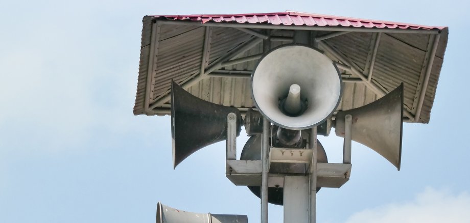 Vintage horn speaker tower with loudspeaker against the sky. Sys