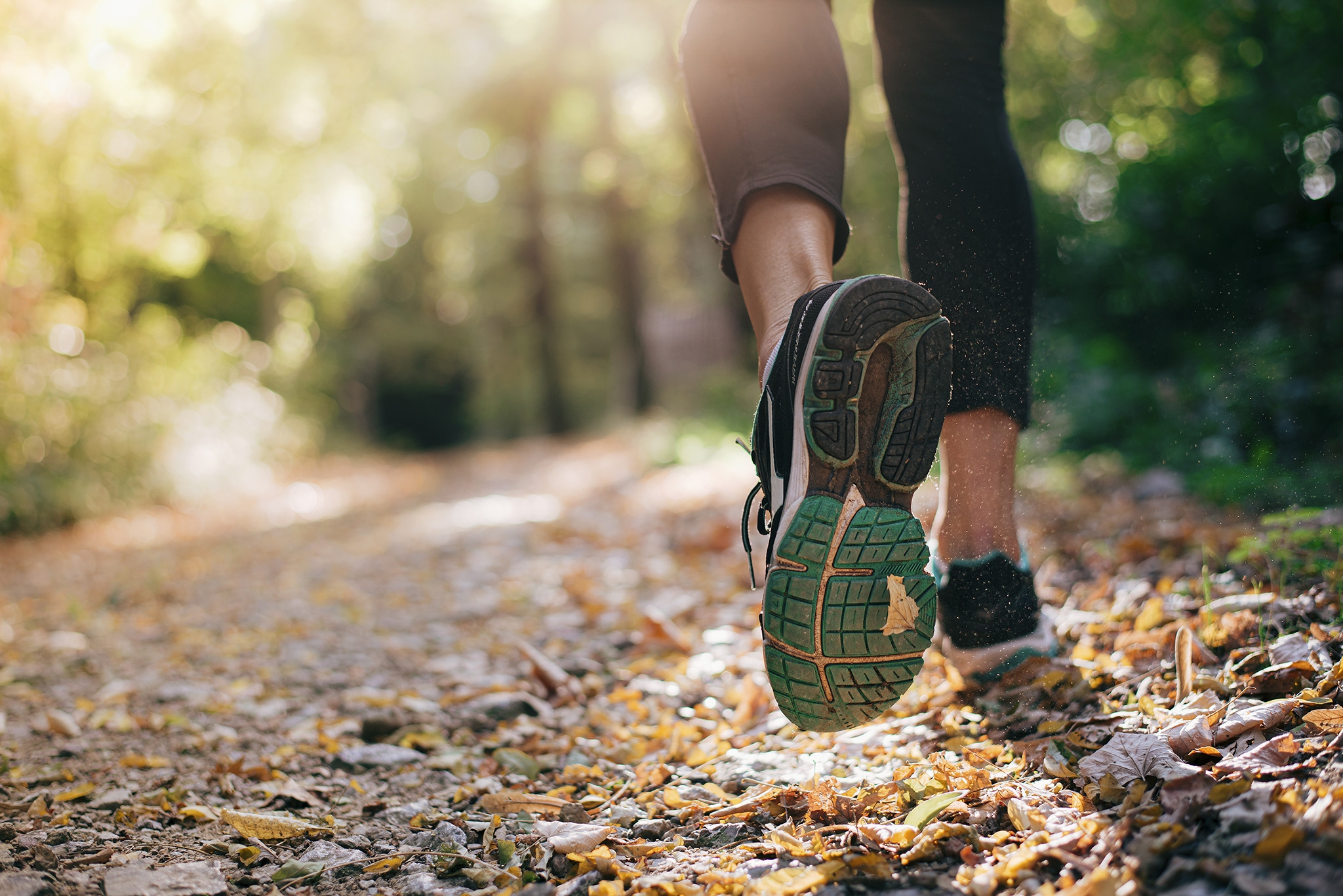 Closeup of running shoe of the person running in the nature with