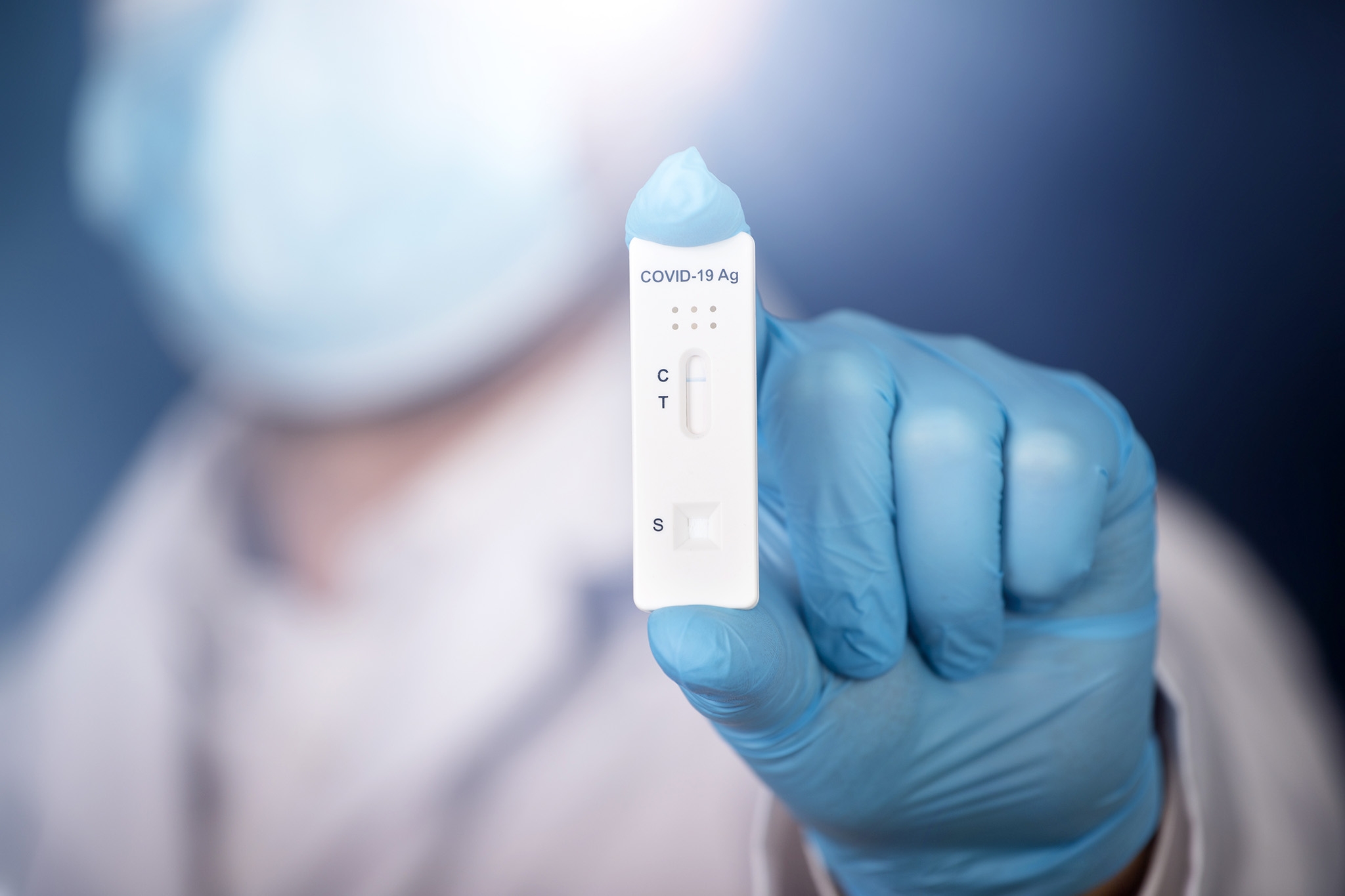 Medic hands in gloves holding negative COVID-19 test, rapid test Medic hands in gloves holding negative COVID-19 test, rapid test