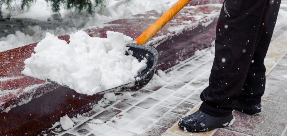 City service cleaning snow , worker cleans a track in a park wit City service cleaning snow , worker cleans a track in a park wit